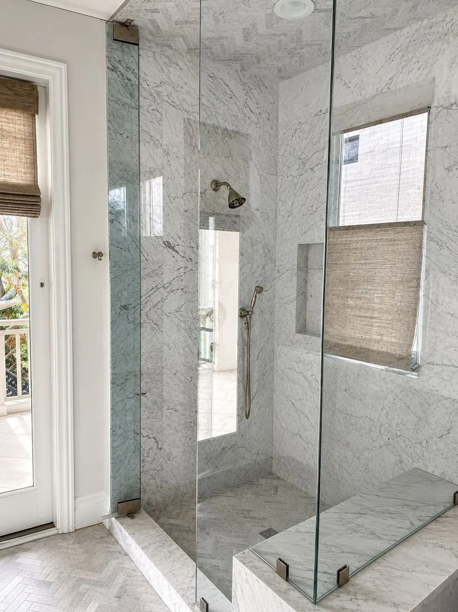 Completed Carrara marble walk-in shower with herringbone detail in Yorba Linda, CA by Serrano Construction